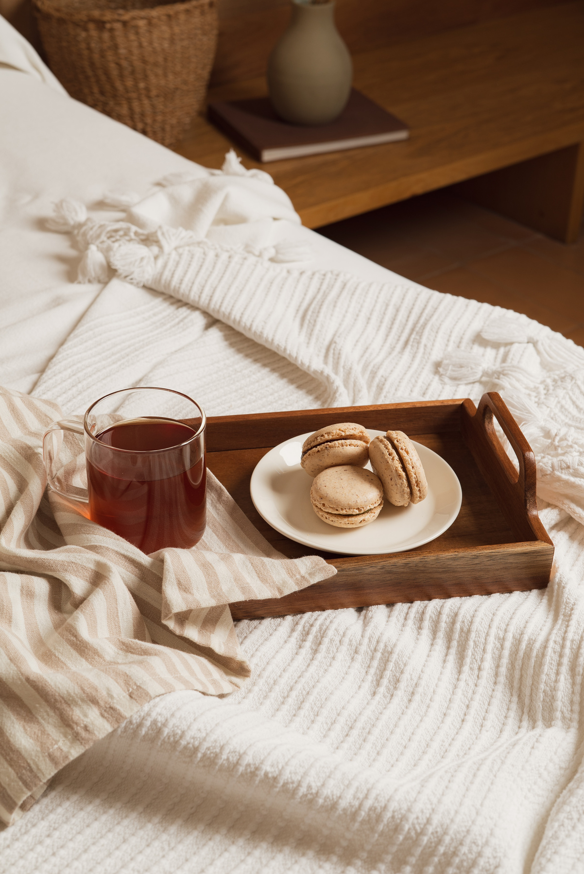 Glass of Tea and Macarons on the Bed